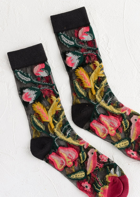 A pair of sheer black socks with multicolor creature print.