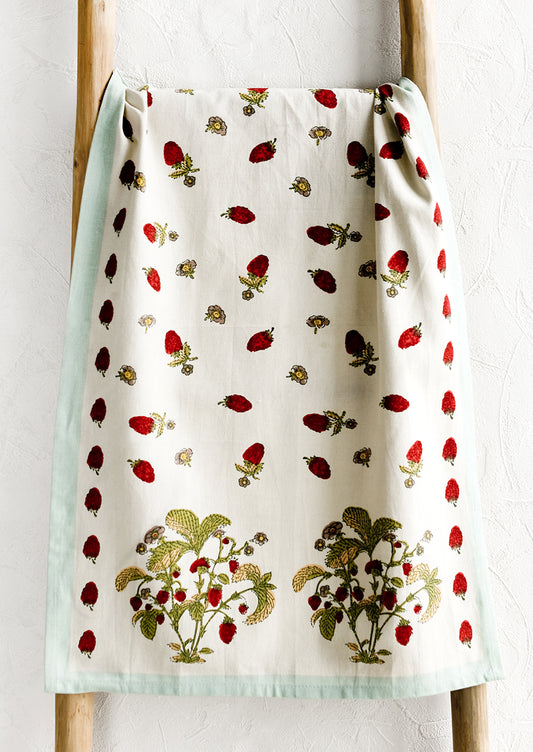 A cotton tea towel with wild raspberry print and aqua border.