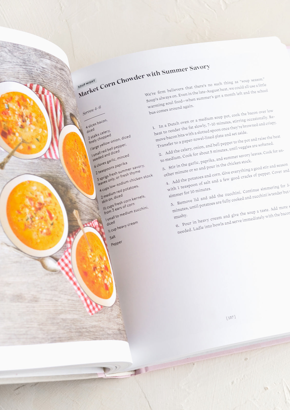 A cookbook open to recipe for market corn chowder.