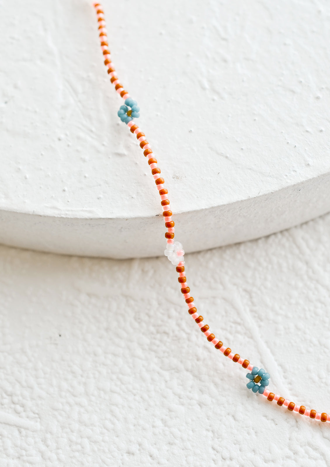 A beaded necklace with daisy design.