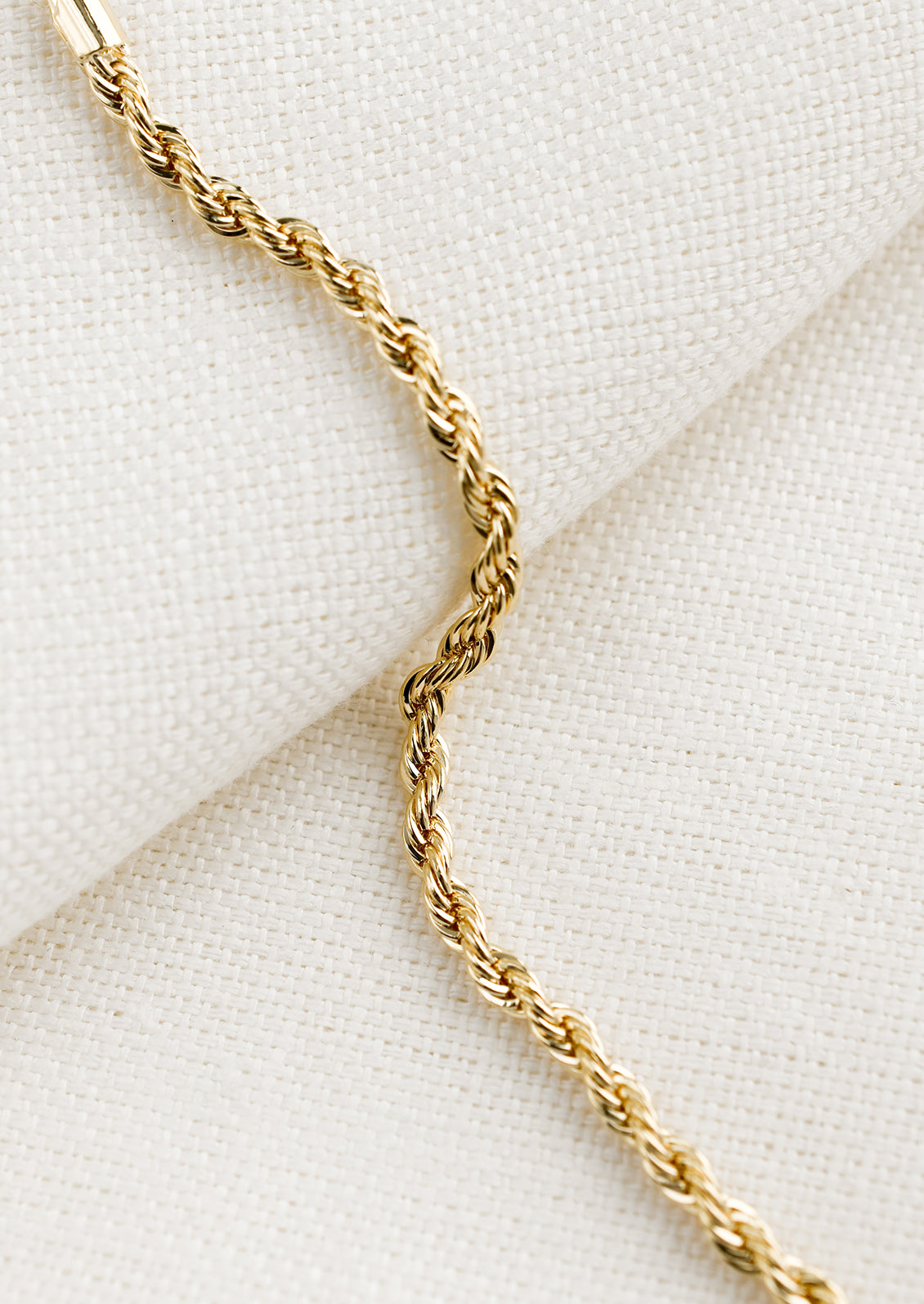 A gold bracelet in rope twist design.