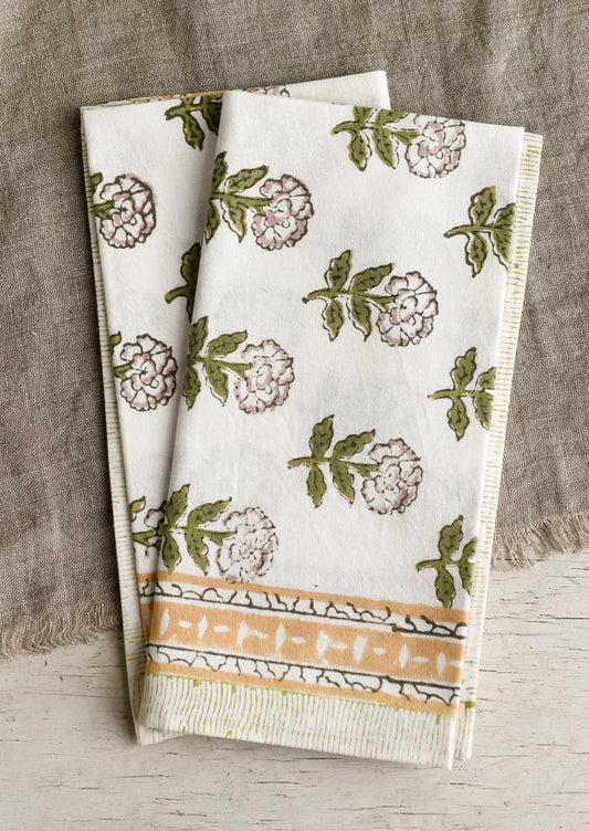 A pair of block printed floral napkins in green, mustard and lavender palette.