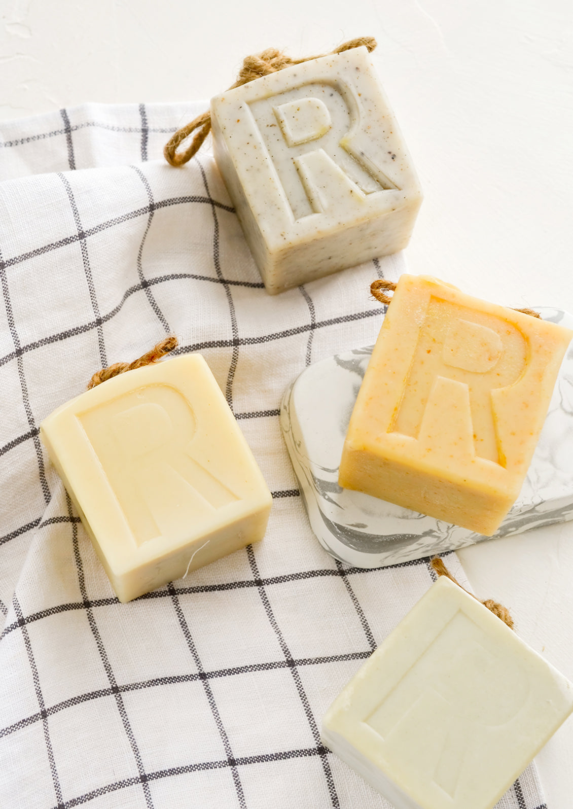 Cube shaped soap bars with embedded rope at top.