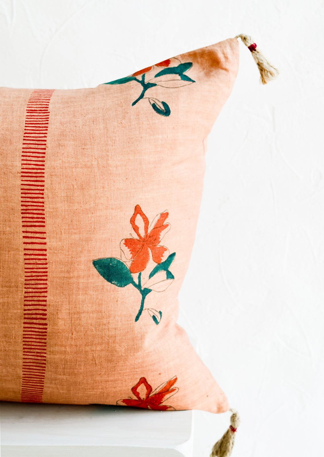 Block printed lumbar pillow in clay brown fabric with red flowers