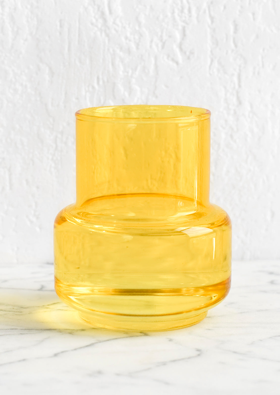 A small yellow glass vase.