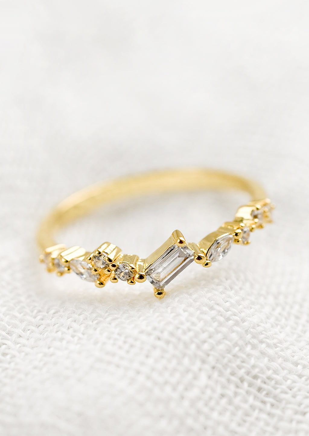 2: A gold ring with askew clear crystals in mixed cuts.