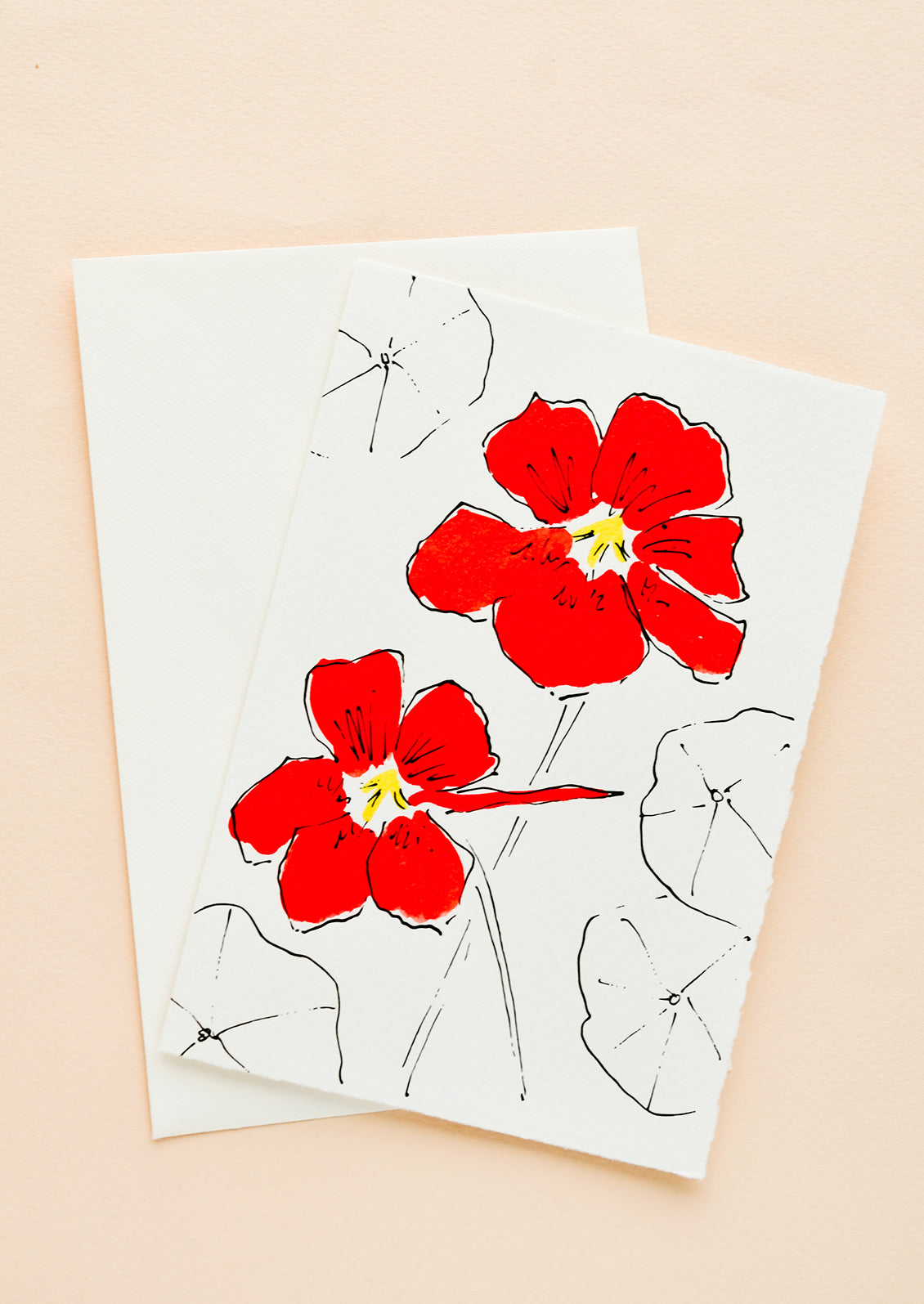 A white greeting card with a hand painted illustration of red nasturnium.