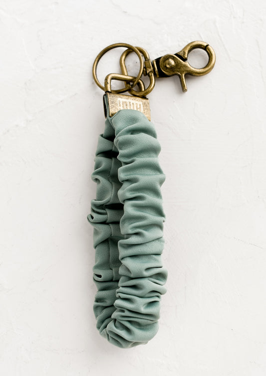 A scrunchie wristlet keychain in dusty mint.