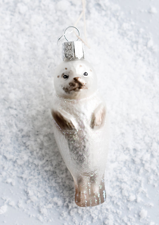 A decorative glass ornament in the shape of a seal pup.