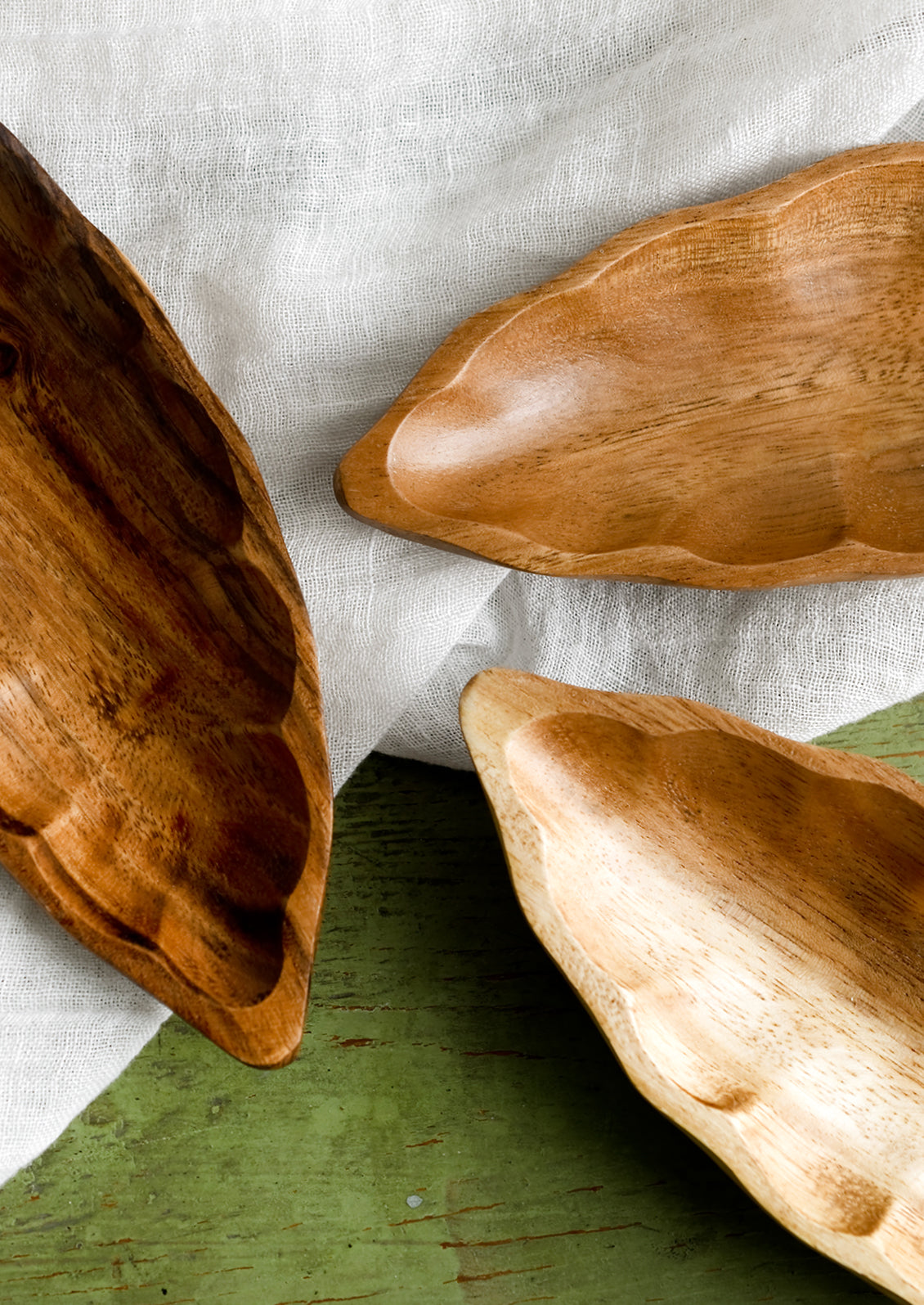 Seedpod shaped dishes in slightly varying shades of wood tone.