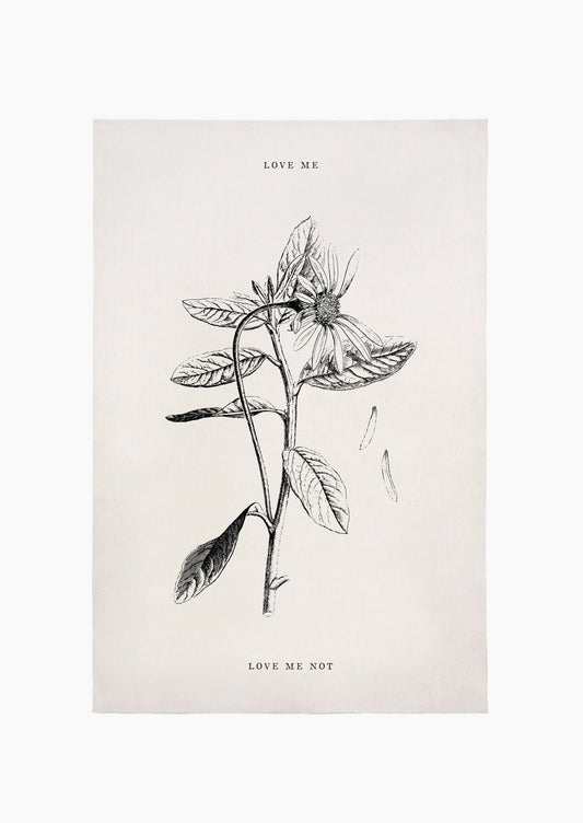 A white linen tea towel with floral image and text reading "love me" and "love me not".