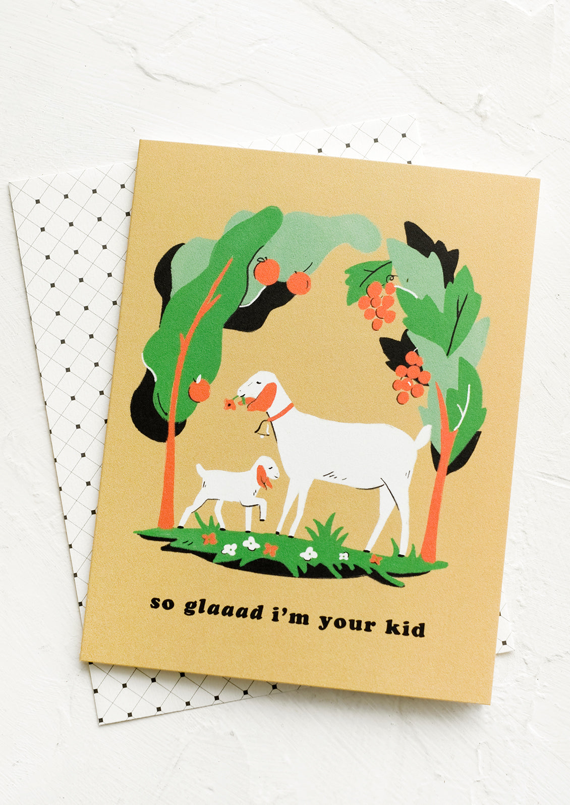 A greeting card with image of goat, card reads "So Glaaaad I'm Your Kid".