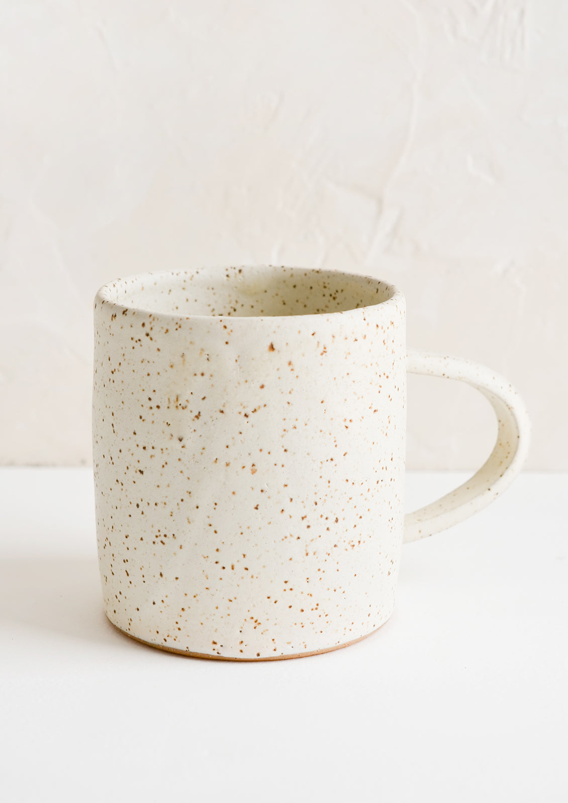 A speckled white coffee mug.