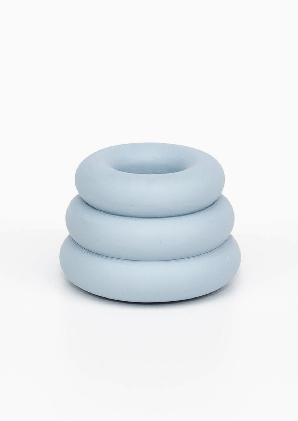 A taper candle holder with 3-layer stacked donut shape in sky blue.