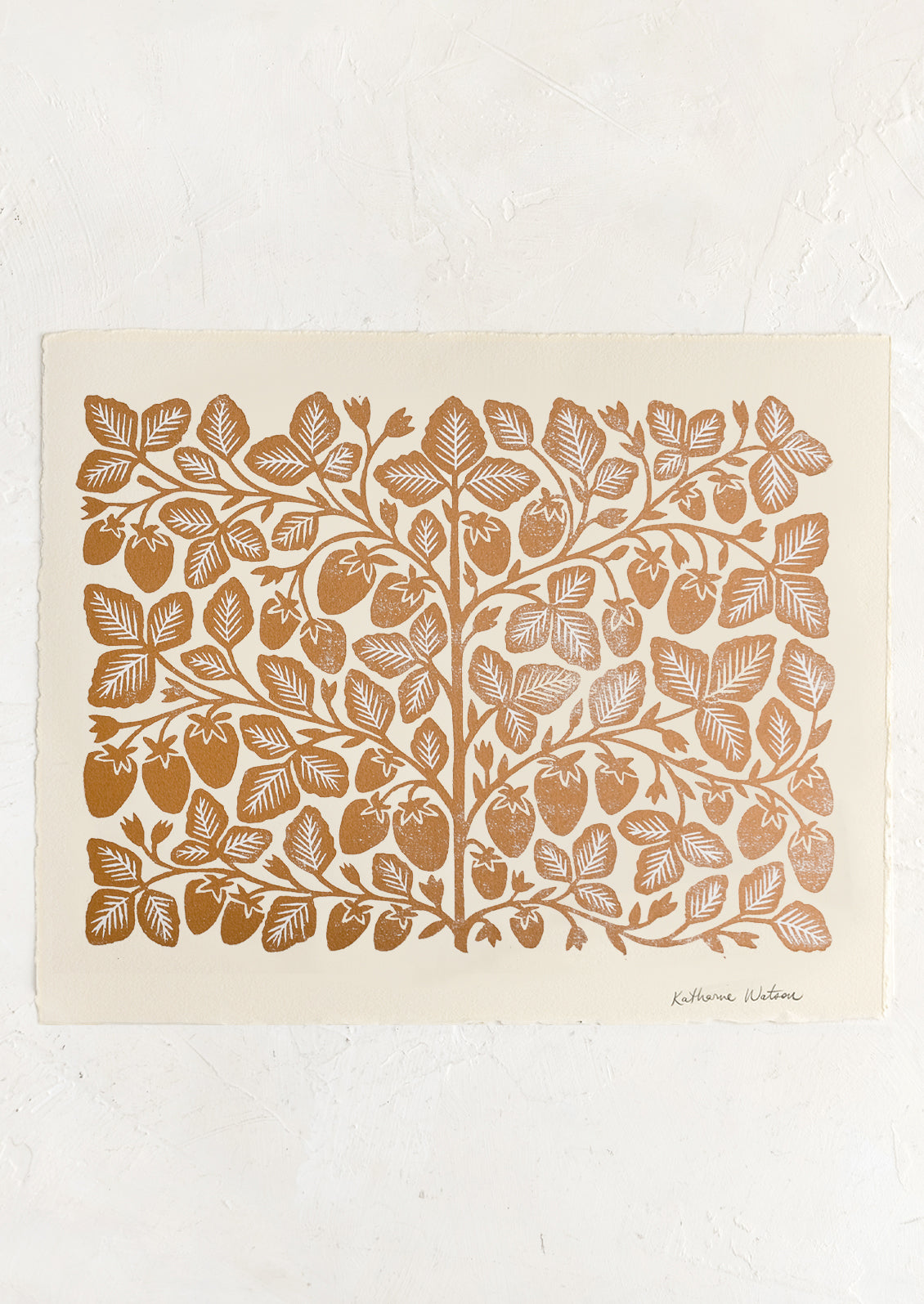 An ivory deckled edge paper with woodcut strawberry print in gold ink.