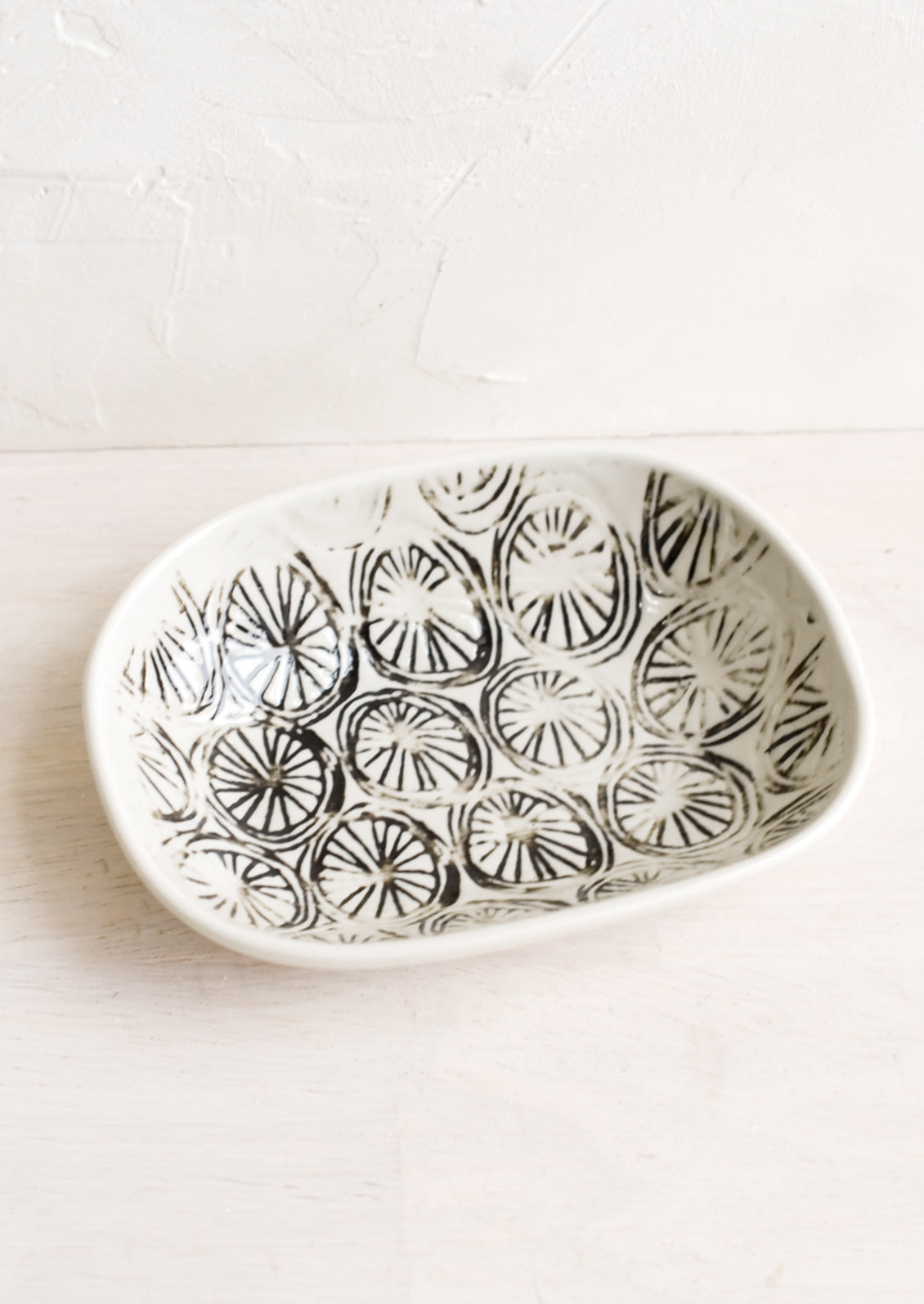 A small oval ceramic dish in pinwheel pattern.