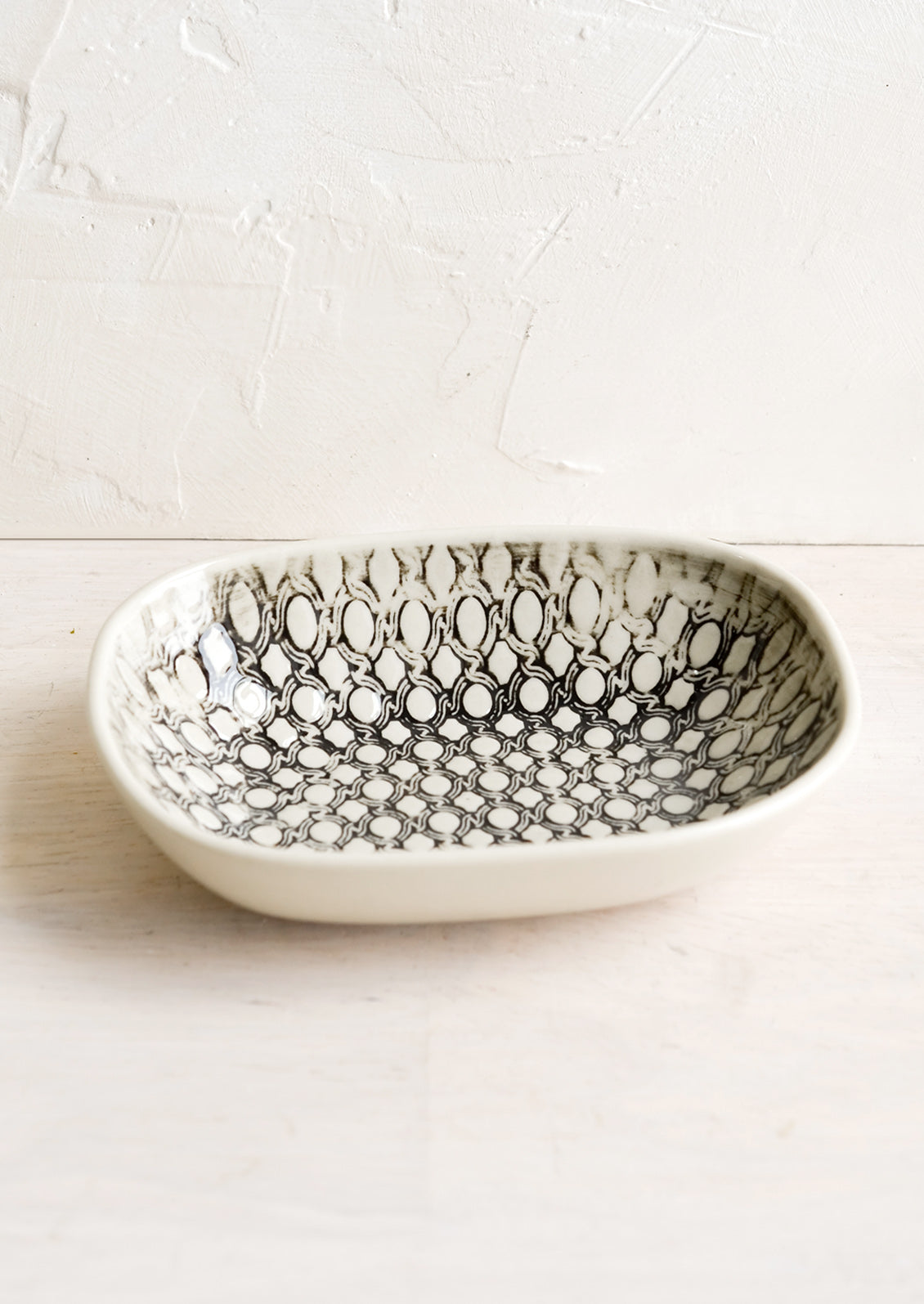 A small oval ceramic dish in rope pattern.