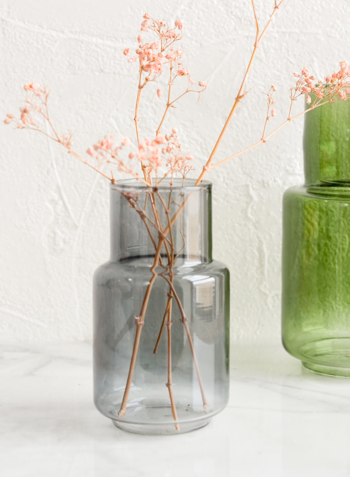 Tinted glass vases in blue and green.