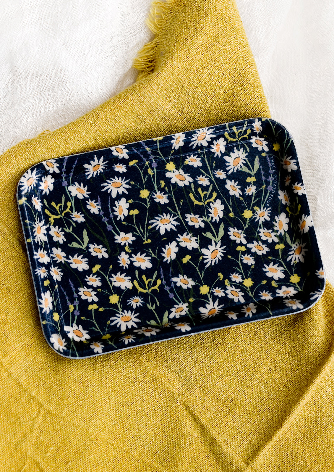 A navy daisy print rectangular tray.