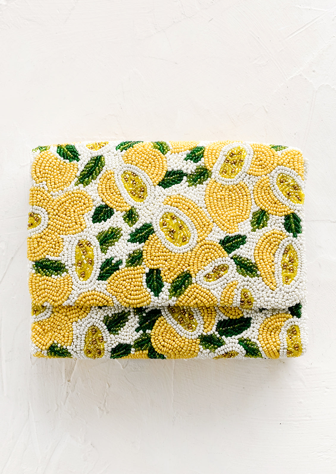 A beaded box-shaped clutch with lemon citrus print.