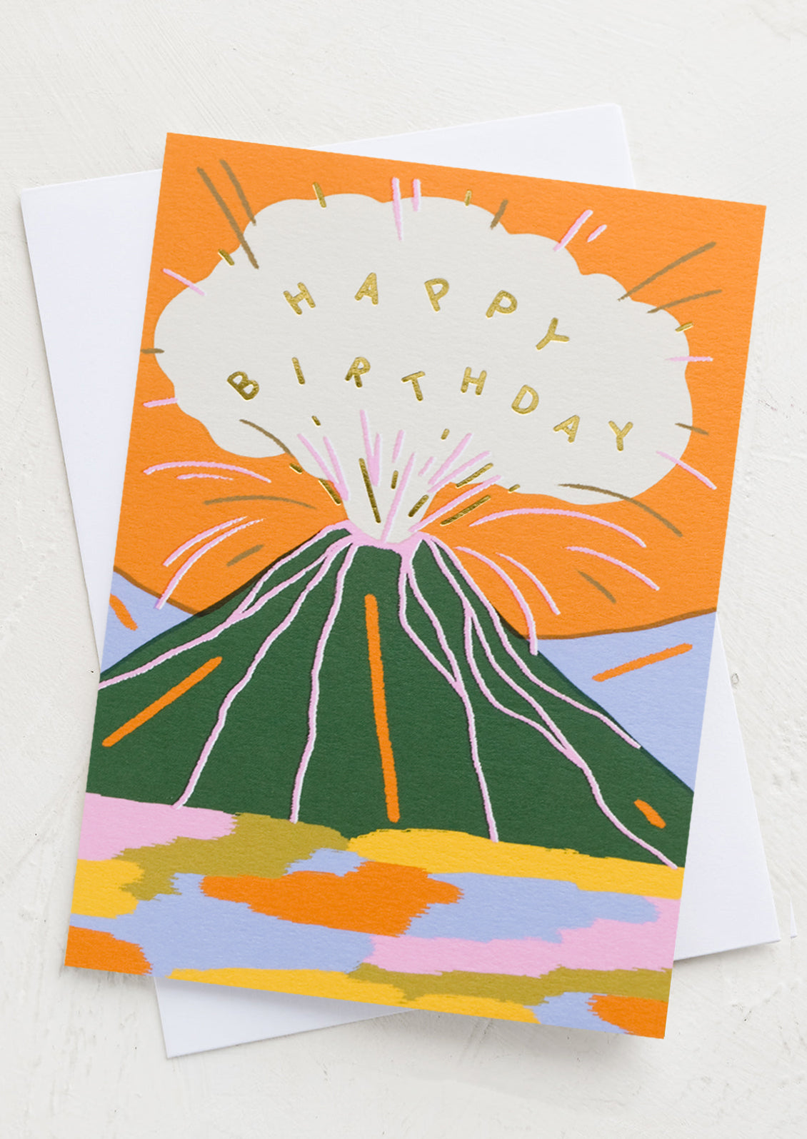 A birthday card with illustrated graphic of exploding volcano reading "Happy Birthday".