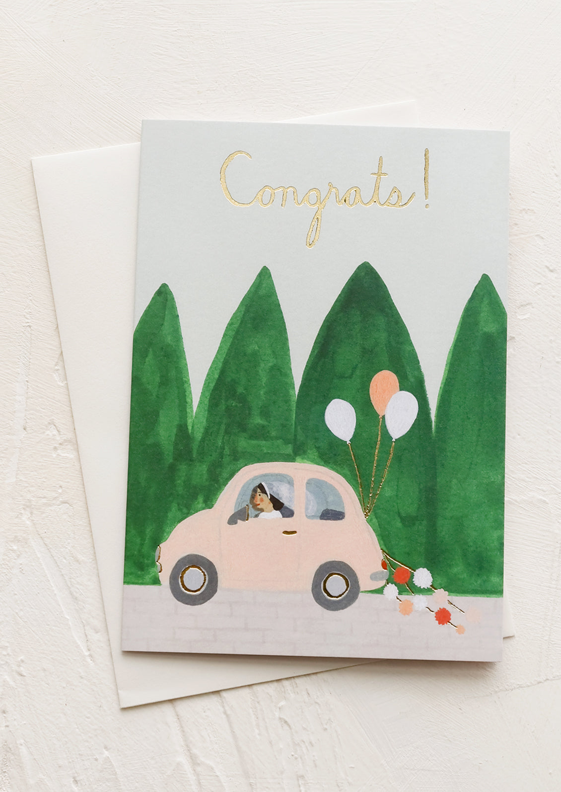 An illustrated greeting card with bride in a car with balloons, text reads "Congrats!"