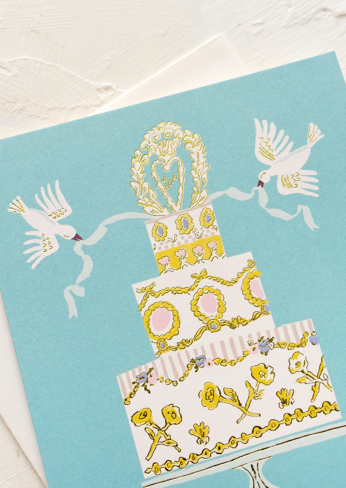 A greeting card with illustration of wedding cake with doves.