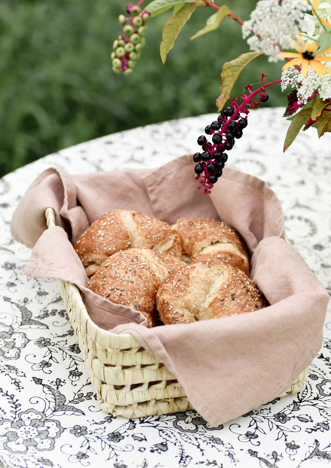 Croissants on a table with grey printed tablecloth.