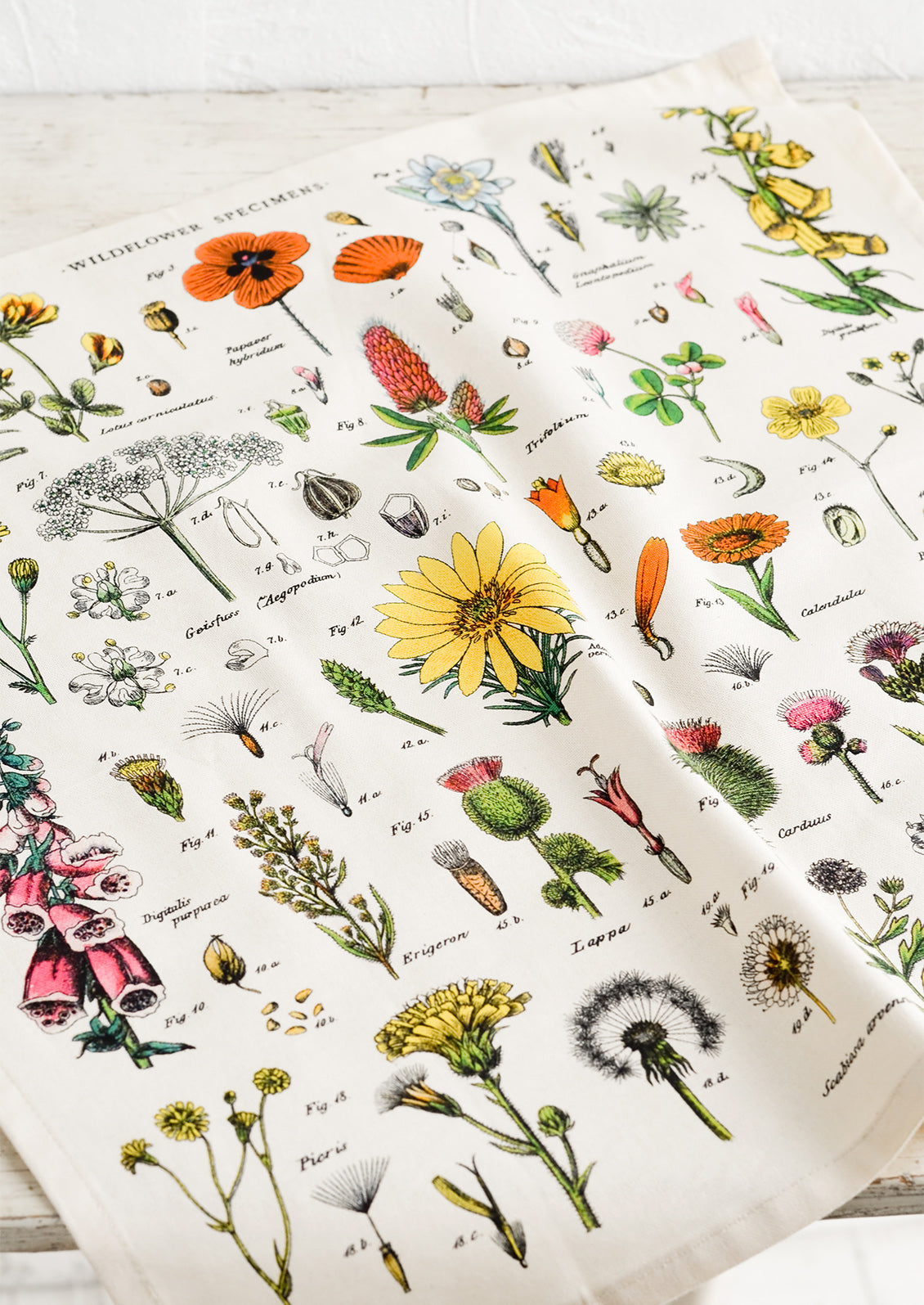 A square cotton dinner napkin with colorful botanical wildflowers print.