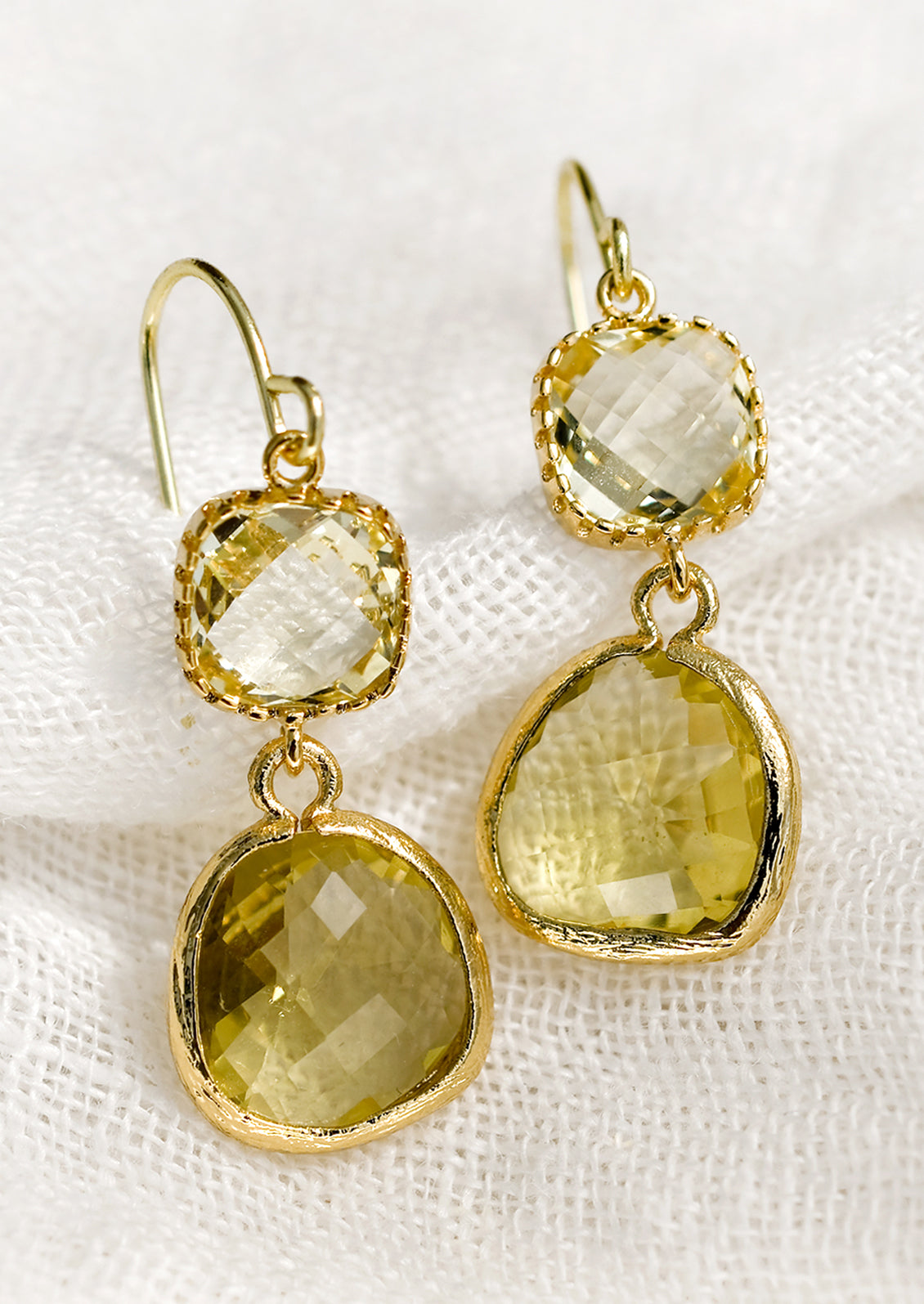 A pair of two-stone bezeled gem earrings in champagne and citrine.