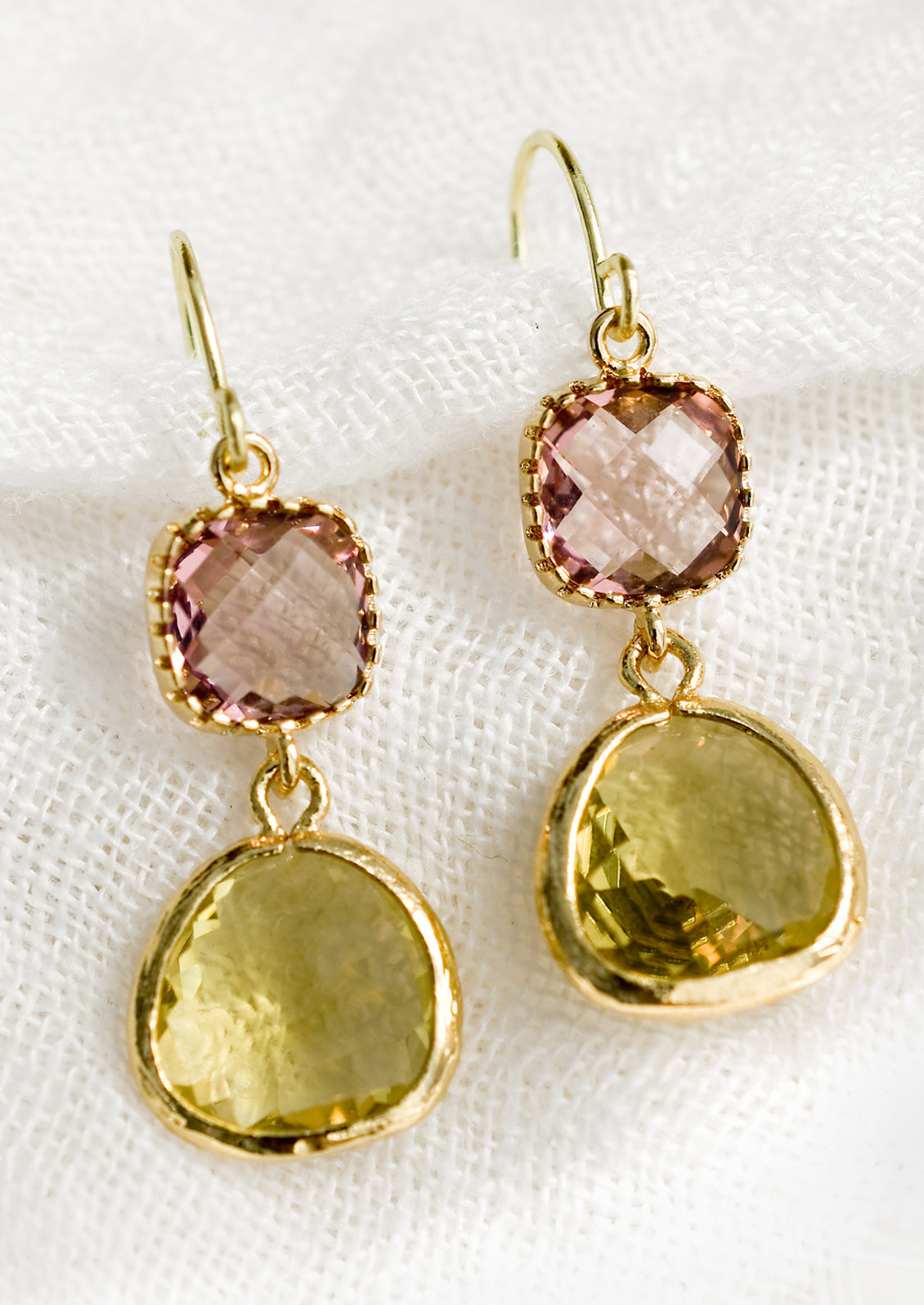 A pair of two-stone bezeled gem earrings in rose and citrine.