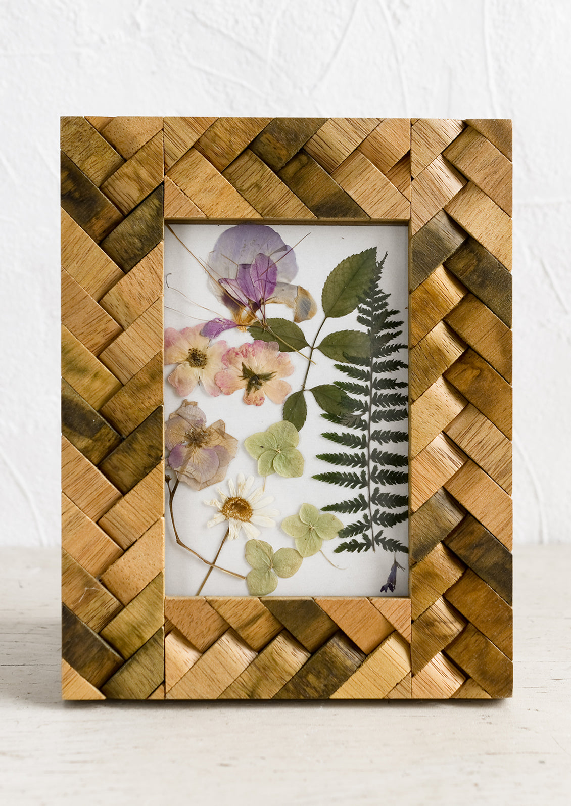 A wooden picture frame with basketweave texture.