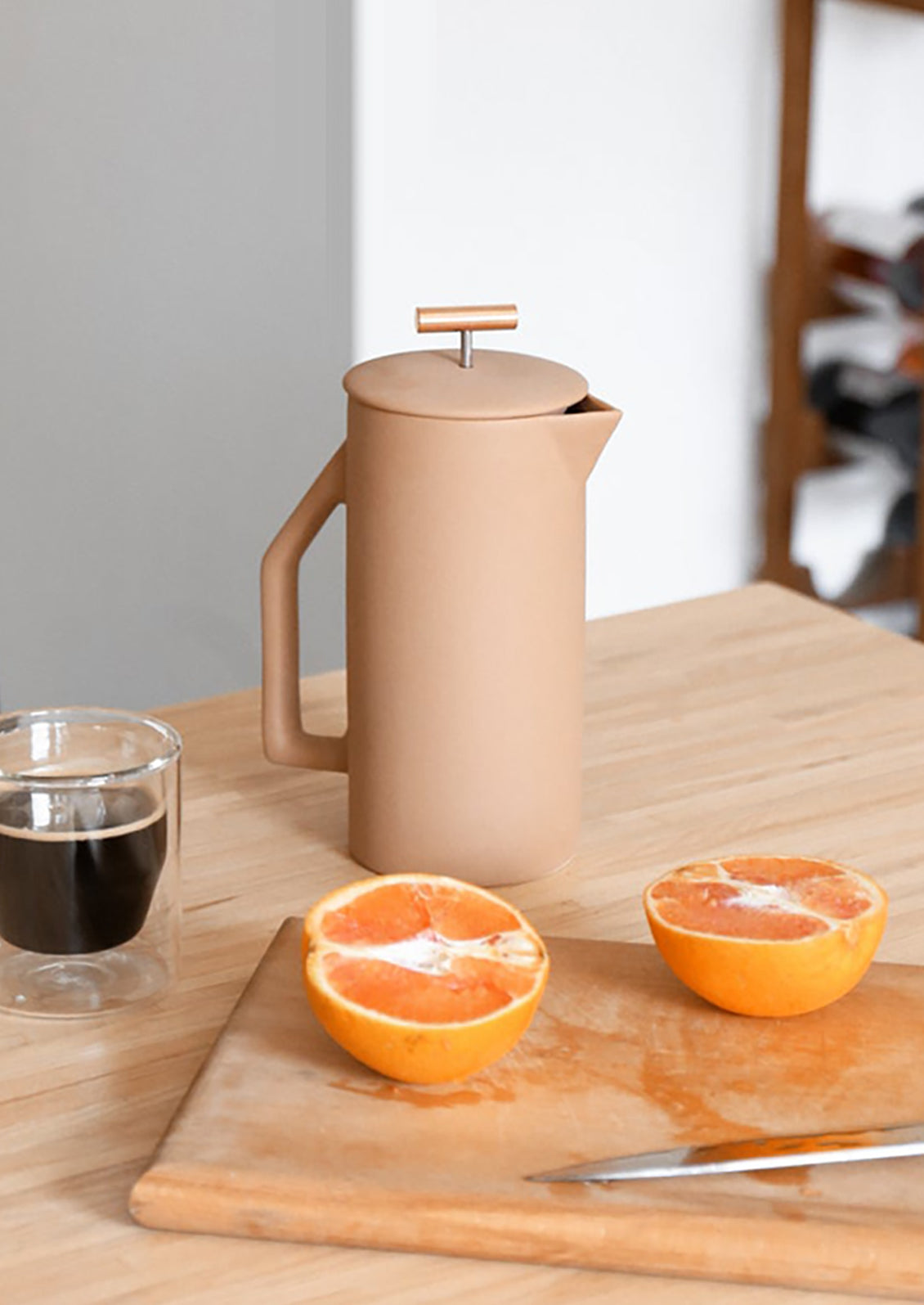 A french press coffee maker in matte tan ceramic.